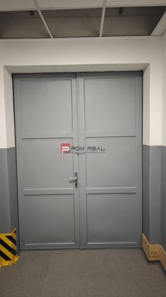 Gray metal double-door gate in warehouses and halls.