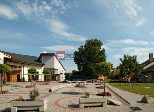Courtyard in Rovinka on Centrum Street, with adjacent buildings and a children's playground.