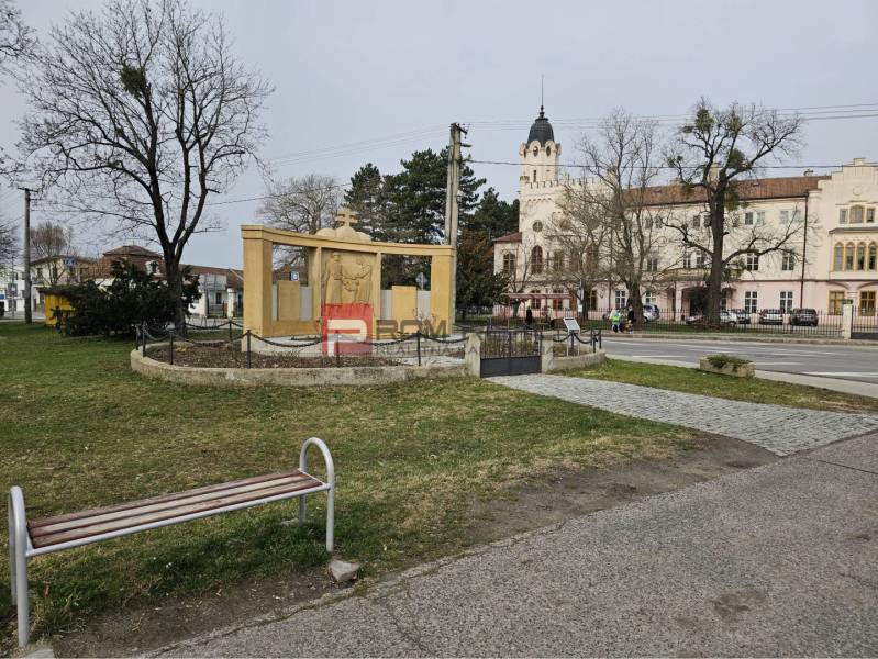 Statue with a memorial, bench, and historic building in Ivanka pri Dunaji on Ivanka pri Dunaji street.