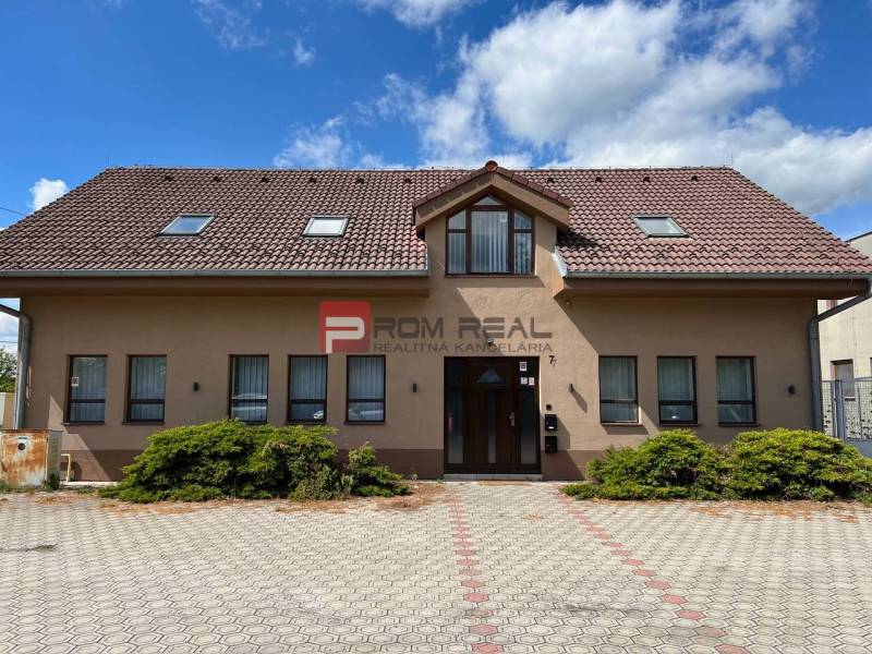 Production premises on Nová Street in Pezinok with a large paved area in front of the building.