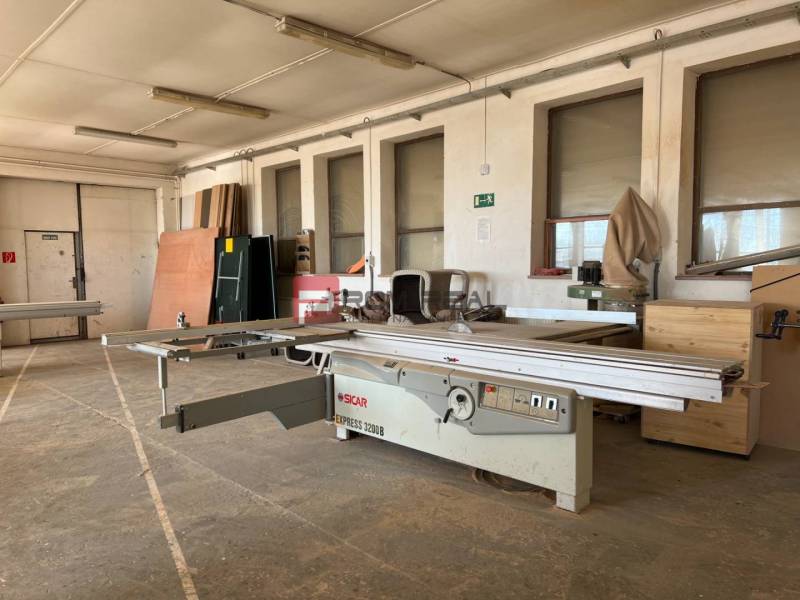 Interior of manufacturing premises with woodworking machines and wooden materials on Nova Street in Pezinok.