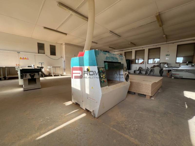Production facilities with woodworking machines and materials ready for processing.