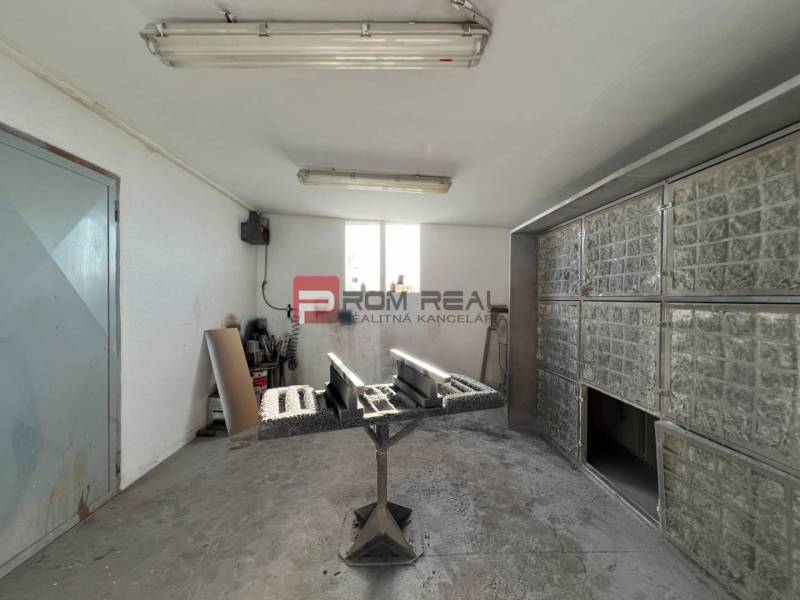 Production premises with a workbench, equipment, and lighting.