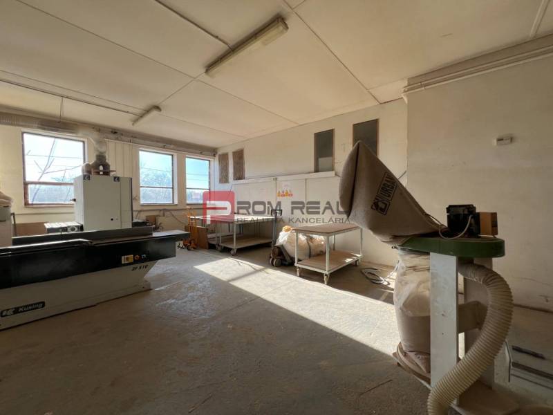 Production facilities with equipment in the room, containing machines and workbenches.