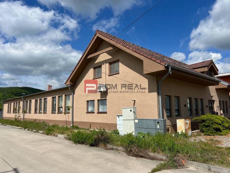 Production premises on Nová Street in Bratislava III, with a blue sky and greenery.