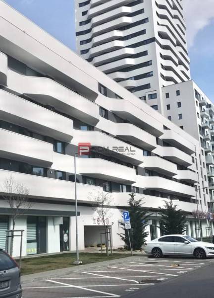 A building with balconies on Údernícka Street in Bratislava V, garages in the foreground.