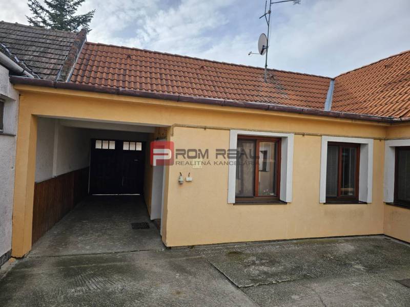A family house on Slnečná Street in Pezinok with a garage and a satellite dish.