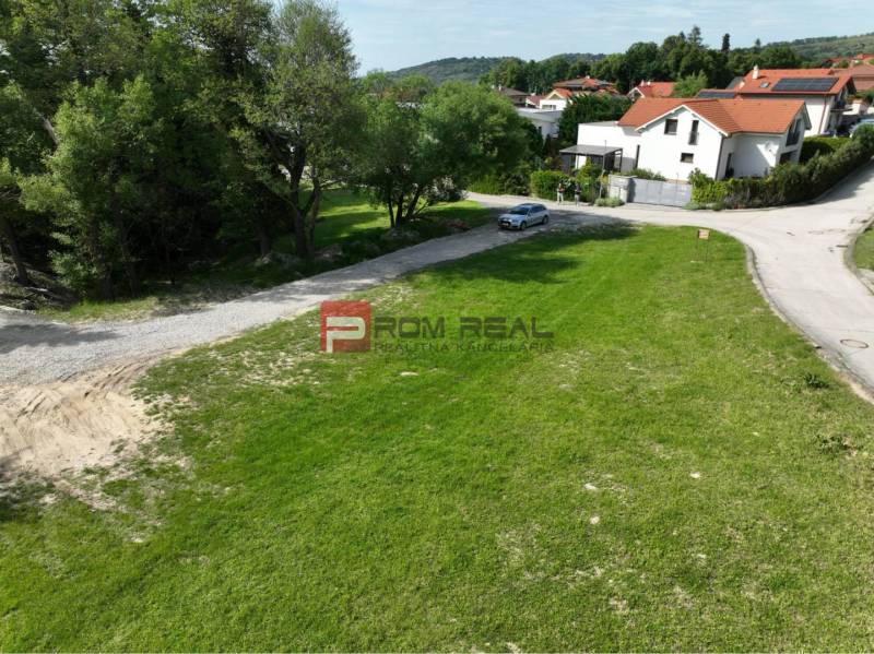 A residential plot in Marianka on Na tálkoch street surrounded by greenery and a road.