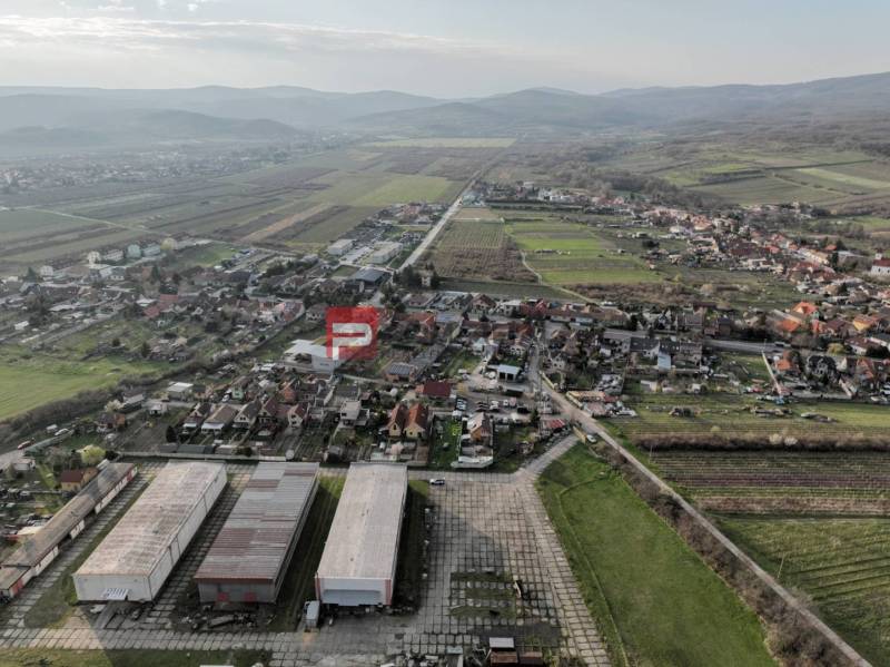 A view of the production facilities in Vinosady on Pezinská Street surrounded by vineyards.