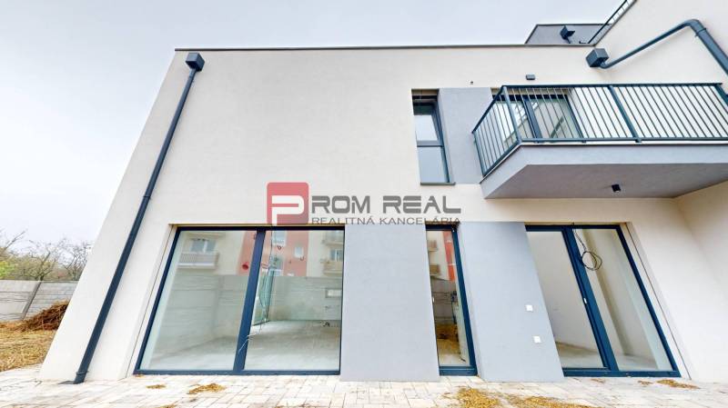 Family house on Bottova Street in Miloslavov with glass doors and a balcony.