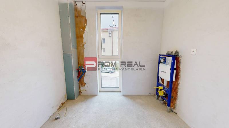 An empty room with plumbing installation for a future bathroom in a family house.