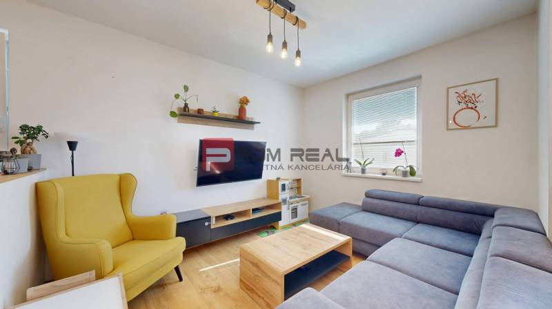 A living room with a comfortable sofa and a yellow armchair in a 3-room apartment.