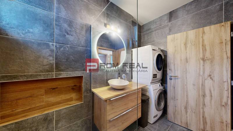 Bathroom in a 3-room apartment, with a mirror, cabinet, and a washer with dryer.