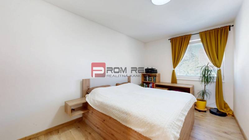 A bedroom with light walls and a wooden bed in a 3-room apartment.