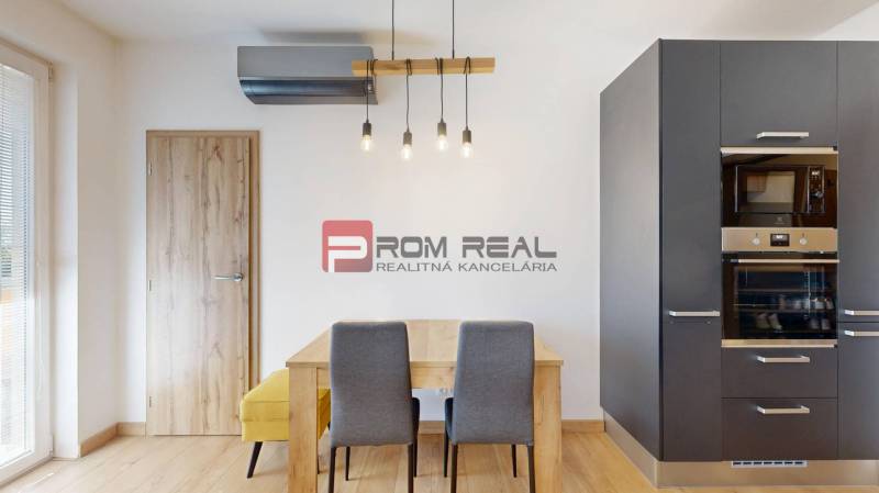 Dining table with chairs in a 3-room apartment, built-in kitchen unit with an oven.