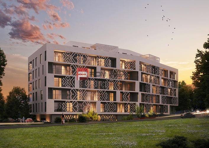A modern apartment building in Bratislava III with evening lighting and green surroundings.