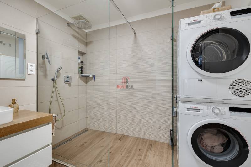 Bathroom with shower and washing machine in a 3-room apartment.