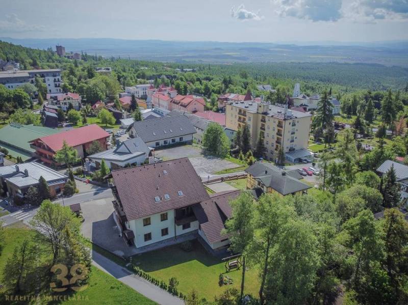 Aerial view of holiday apartments in the High Tatras surrounded by nature and greenery.