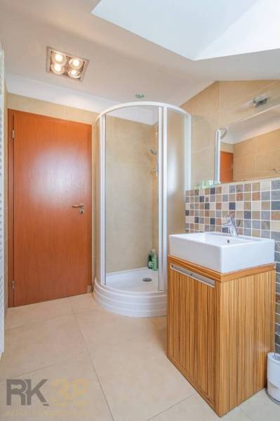 Bathroom in a Holiday Apartment with a shower corner and a square sink.