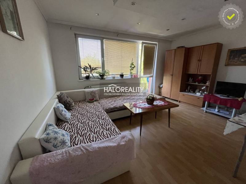 Living room in a 3-room apartment with a sofa, table, cabinet, and television.
