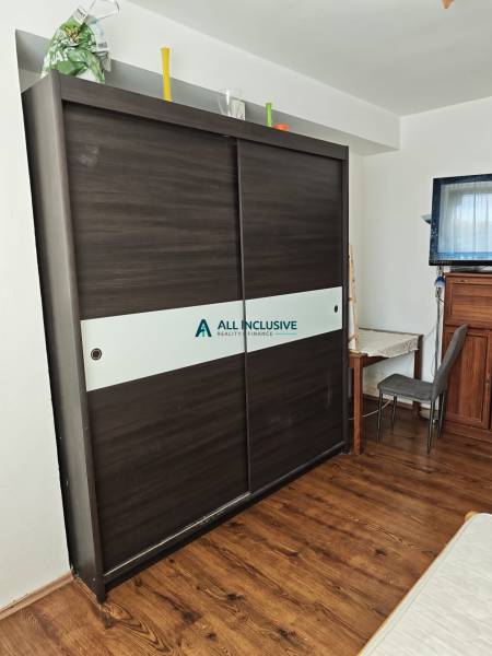 A wardrobe with sliding doors and a writing desk in a 2-room apartment.