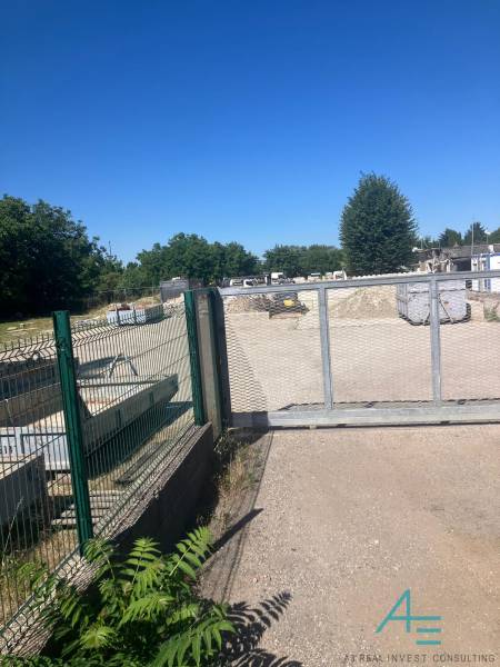 Commercial land on Popradská Street in Bratislava - Podunajské Biskupice, fenced area with a gate.