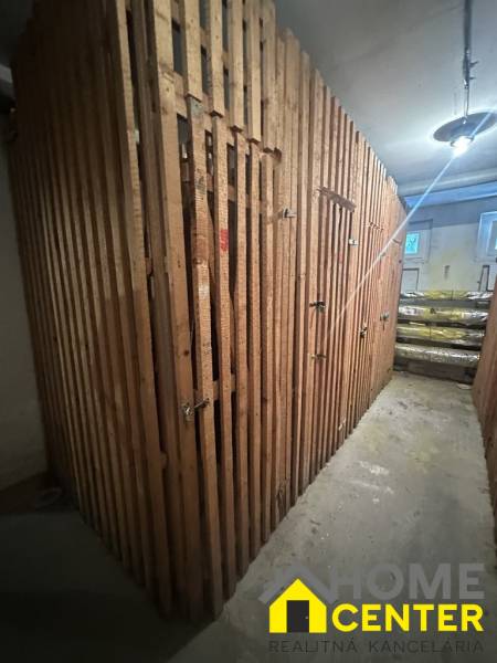 A wooden shed in the basement, secured with locks.