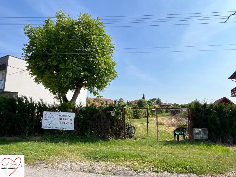 Plots - housing in the village of Dolný Bar, fenced plot with a tree and a gate.