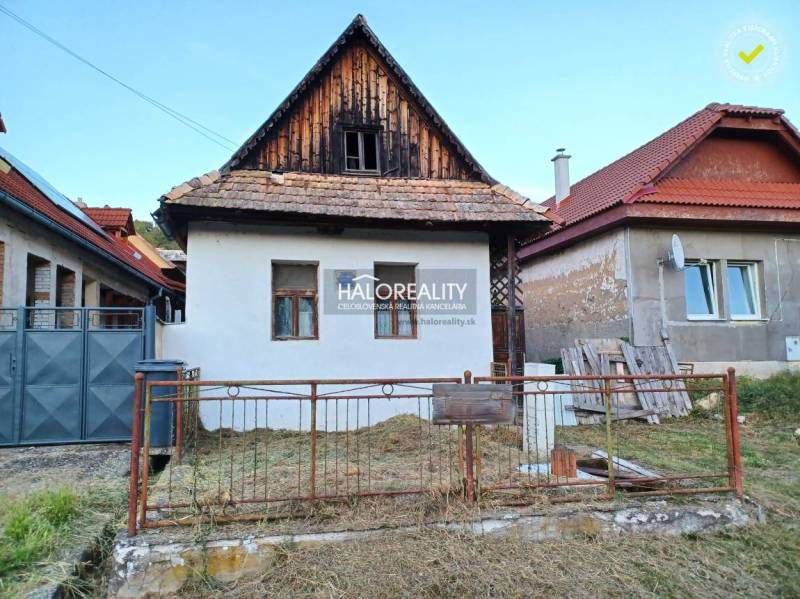 A family house in Ladzany with traditional architecture, a white facade, and a sloped roof.