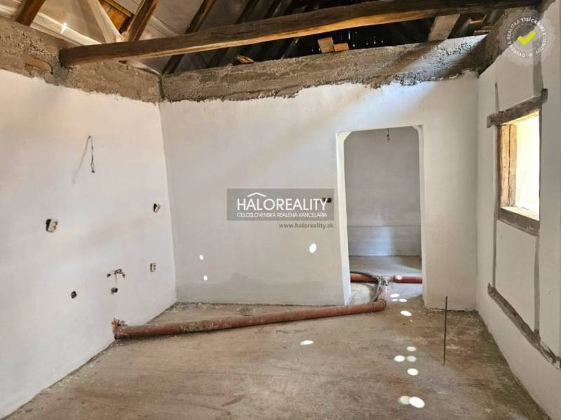 The interior of a family house with an empty room, exposed ceiling beams.