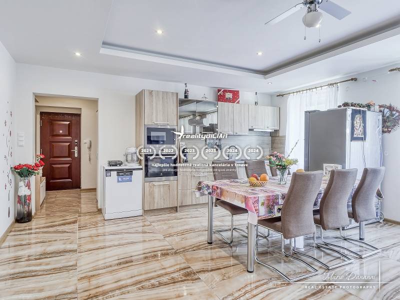 Kitchen in a 2-room apartment with a dining table and entrance door.