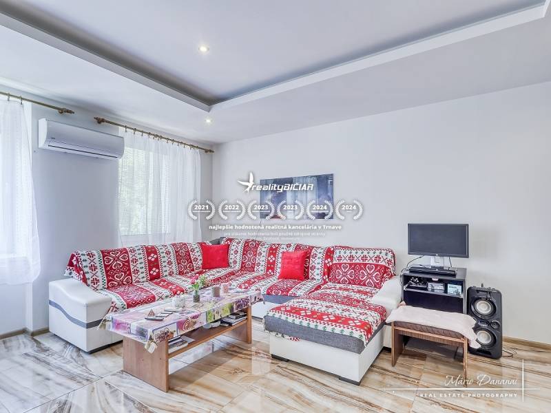 Living room with a red sofa and a table, 2-room apartment, air conditioning.