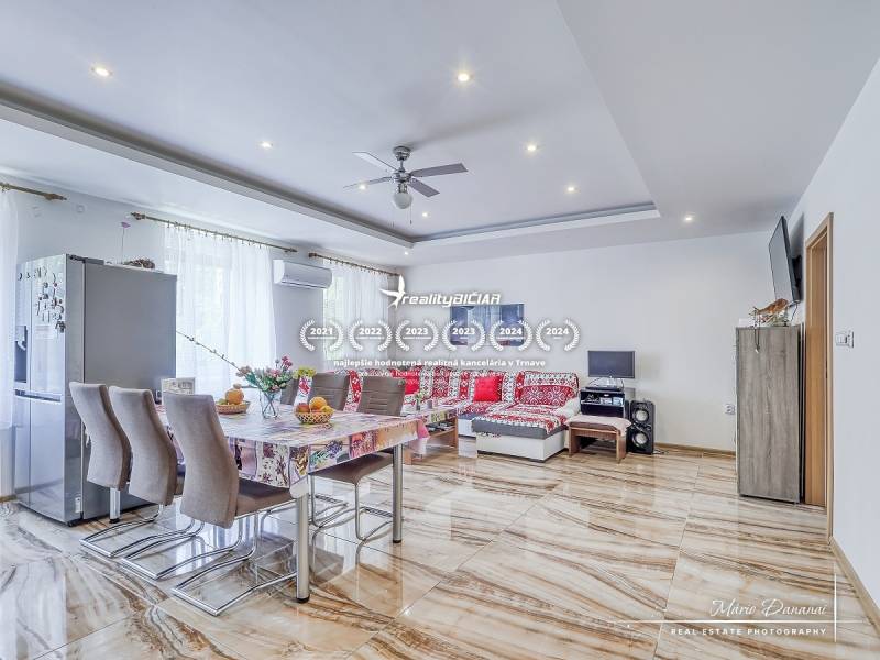 Spacious living area with dining table and sofa in a 2-room apartment.