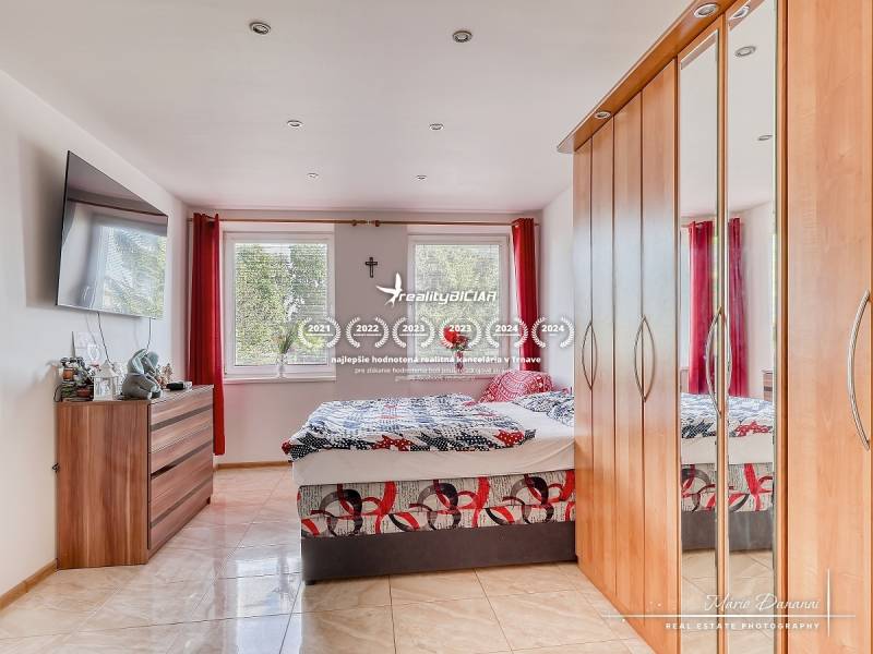 Bedroom with a large wardrobe and television in a 2-room apartment.