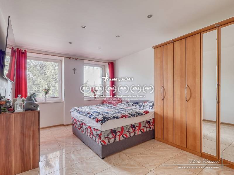 Bedroom in a two-room apartment with a bed, wardrobe, and a TV on the wall.