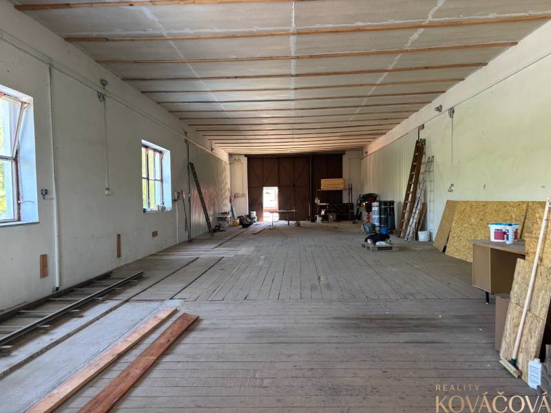 Interiors of warehouses and halls with wooden floors, ladders, and wooden boards on the wall.