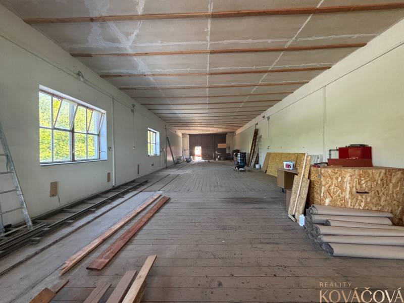 Interior of warehouses and halls with wooden flooring, shelves, and building materials.
