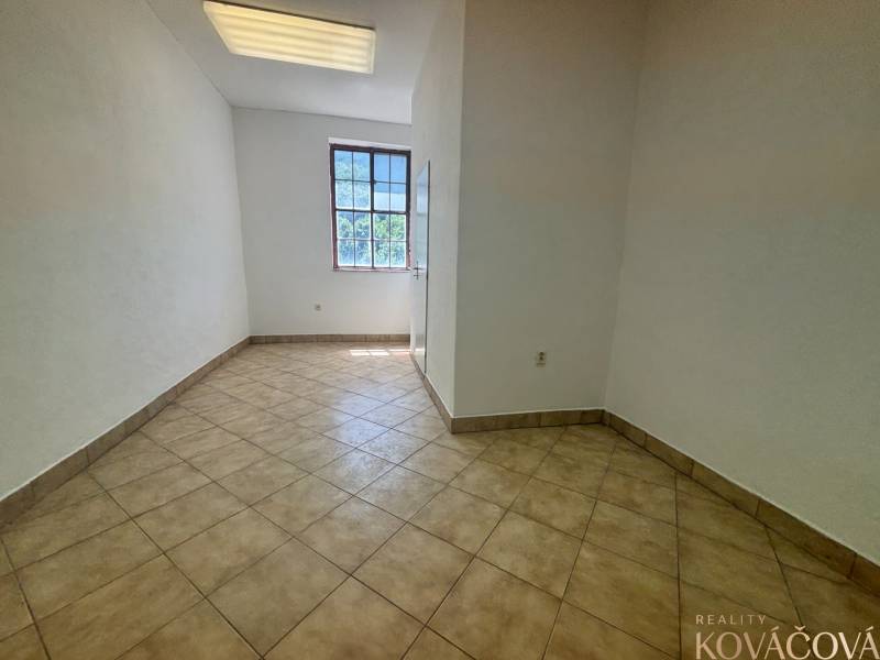 A room with tiles and a large window, suitable for use in warehouses and halls.