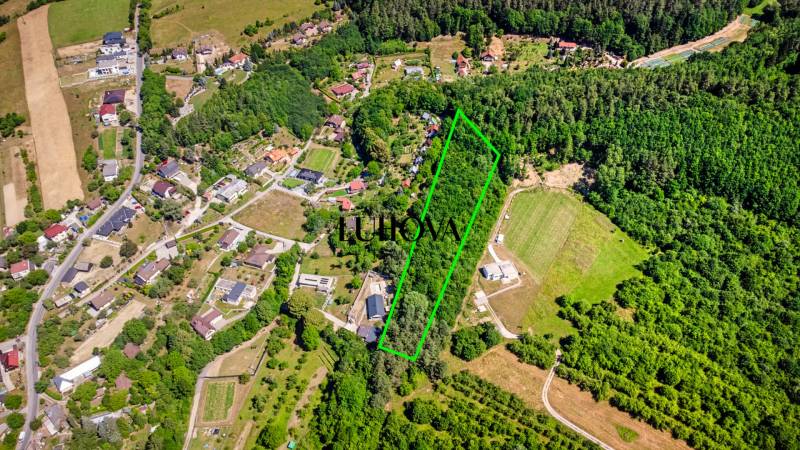 Aerial view of recreational plots in Púchov on Vieska-Bezdedov street, surrounded by greenery.