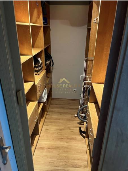 Wardrobe in a 2-room apartment, wooden shelves, practical storage spaces.