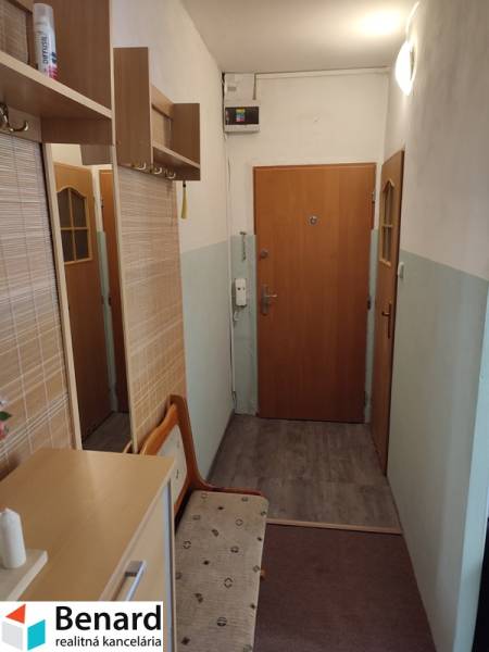Entrance hallway of a 2-room apartment with a shoe cabinet and a coat rack.