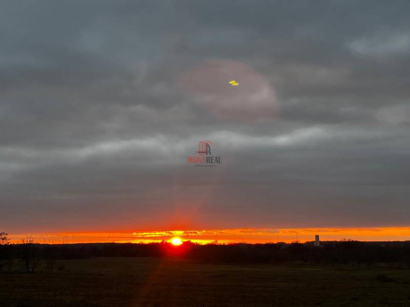 Sunset in Bratislava - Devínska Nová Ves with wind turbines on the horizon.