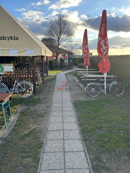 Sidewalk next to gastro spaces with bicycles and umbrellas, Devínska Nová Ves, Devínske jazero.