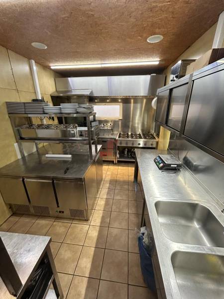 Professional kitchen with stainless steel equipment in catering premises.