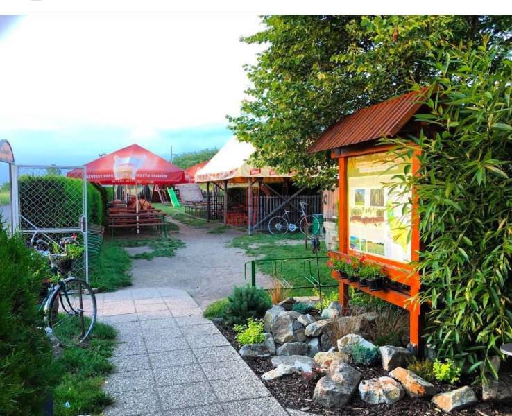 Gastro premises with seating, garden, and information board in Devínska Nová Ves, Devínske jazero.