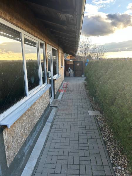 Exterior of the gastro premises at Devínske Jazero in Bratislava, with a renovated walkway.