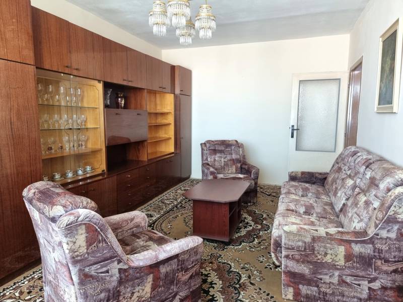 Living room with retro furniture and a carpet in a 2-room apartment.