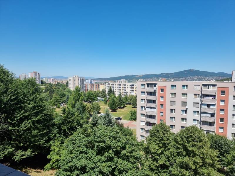 View from Petzwalova Street in Nitra of a 2-room apartment and surrounding panel buildings.