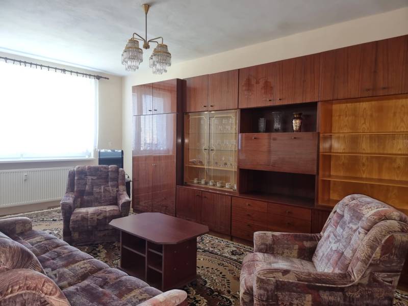 Living room with retro furniture and a sofa in a 2-room apartment.