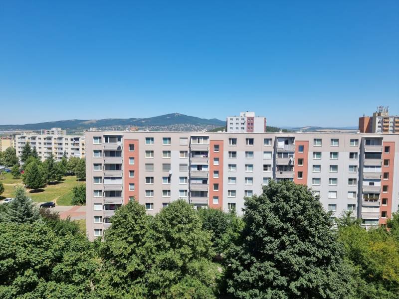 A view of apartment buildings in Nitra on Petzwalova Street, with a view of the surrounding nature.